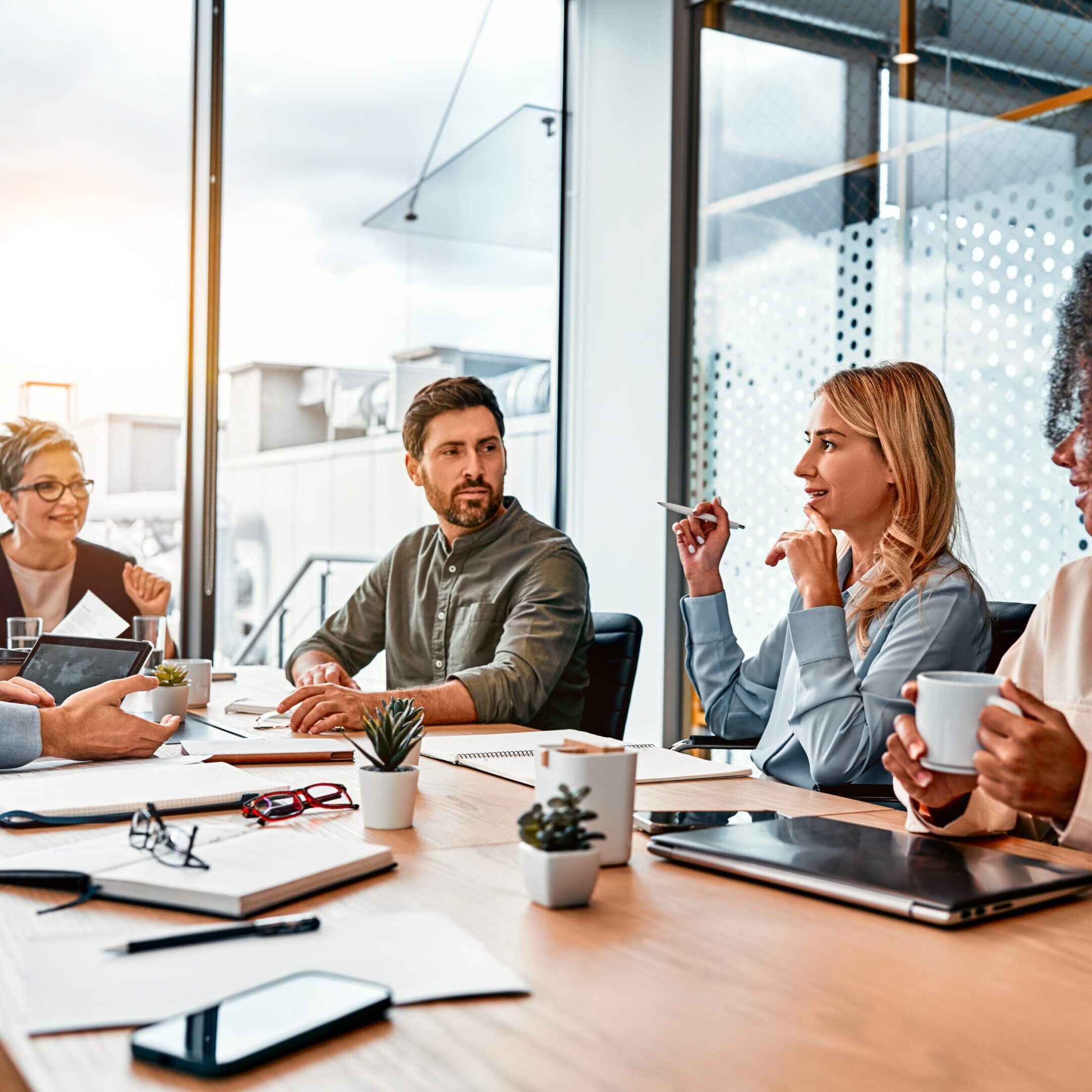 Business team engaged in a meeting around a conference table.